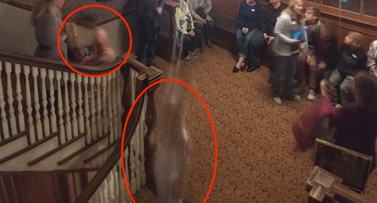 Stairwell at the Stanley Hotel with a group and two ghostly figures circled