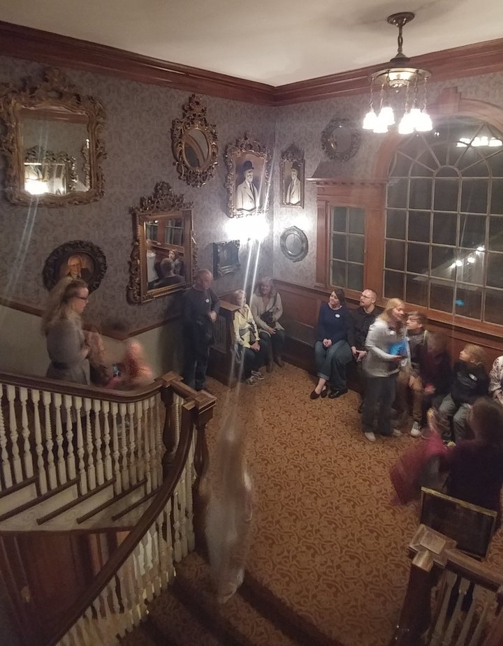 Full photo of the Stanley Hotel group and the two ghostly figures